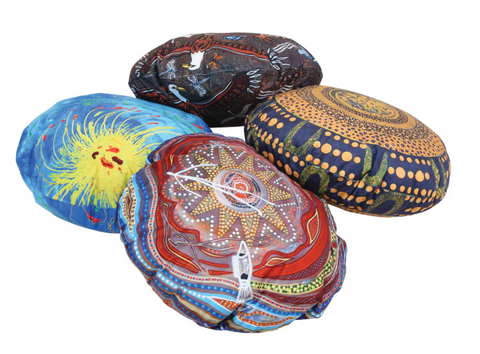 A set of four round Aboriginal cushions featuring authentic indigenous artwork by Billyara and Charlie Wicking.