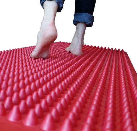 This is an image of two feet walking on an Accupressure Tactile Walkway - great for Autism and Sensory Regulation