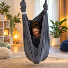 Adult fully enclosed in a charcoal grey Lycra therapy swing