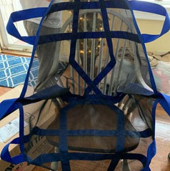 Rescue Perfect Lift with blue straps spread out on chair