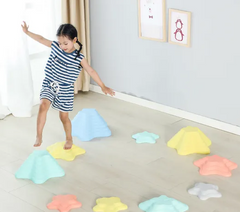 Child using pastel starfish balance stepping stones for gross motor and coordination activities