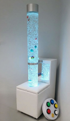 Image of the mobile sensory bundle 150M including a bubble tube, wireless interactive controller leaning on the side, a mobile sofa podium, and a wall bracket.