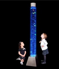 Image of 2 children looking at a tall bubble tube with floating fish