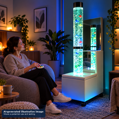 An adult is using a controller to operate a bubble tube in a peaceful and relaxing environment.