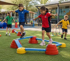 Children enjoying a Build N’ Balance course in a vibrant outdoor school playground.