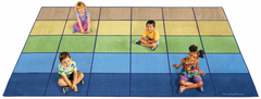 Four children sitting on a Calming Colours Classroom Rug with natural tones for inclusive learning spaces