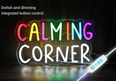 Neon sign with 'CALMING CORNER' text and control panel on a dark background