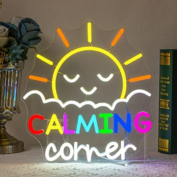 Neon sign with a sun design and 'CALMING CORNER' text on a neutral background.