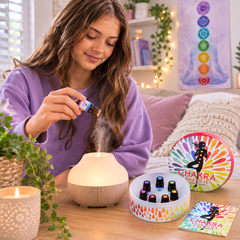 Teenage girl using Chakra essential oils with an aromatherapy diffuser at home.
