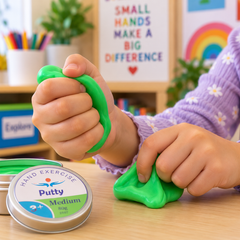 Close-up of young hands squeezing and moulding green Hand Exercise Putty on a classroom table, demonstrating a tactile hand-strengthening activity.