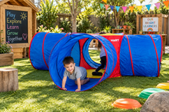 Crawling Cross Tunnel 4-way activity tunnel with children crawling through it in a colourful outdoor early learning playground