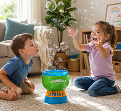 Two young children laughing and playing with a Fubbles Bubble Machine in a bright home setting, reaching for floating bubbles during fun sensory play.