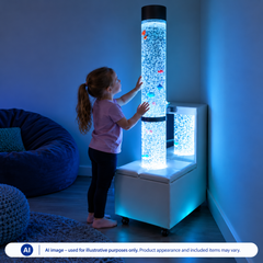 A child standing in a room, touching a bubble tube that is set in a mobile podium.