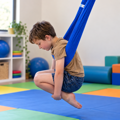 Child using Lycra therapy swing under arms