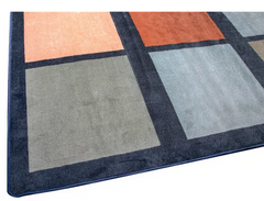 Close up of the Colours of Australia square classroom rug with earthy tones and structured pattern