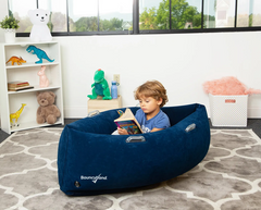 Child quietly reading in the 48" Comfy Hugging Peapod Sensory Pod in blue.