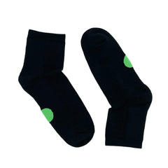 Pair of Dot on a Sock black quarter crew socks with green dot on soles