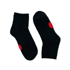 Pair of Dot on a Sock black quarter crew socks with red dot on soles