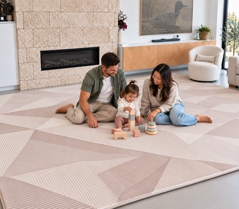 A couple and toddler playing with wooden blocks  on a Dusty Facet Designer Print Memory foam mat in a modern living room.