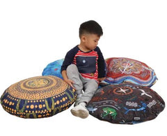 Child sitting amoungst 4 billyara and charlie wicking round cushions 60cm