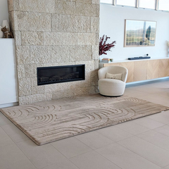 Mocha coloured Cloud Haven Soft Touch Mat  featuring a plush 35mm high-resilience foam surface and contemporary carved pattern placed in a living room next to stone fireplace and comfy chair