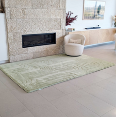 Pistachio coloured Cloud Haven Soft Touch Mat featuring a plush 35mm high-resilience foam surface and contemporary carved pattern placed in a living room next to stone fireplace and comfy chair