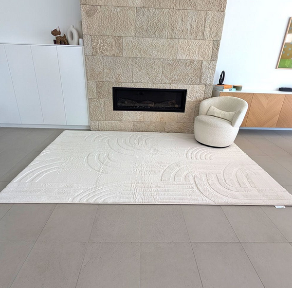 Vanilla Cream coloured Cloud Haven Soft Touch Mat featuring a plush 35mm high-resilience foam surface and contemporary carved pattern placed in a living room next to stone fireplace and comfy chair