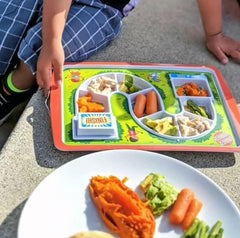 This is an image of the Original FRED Dinner Winner Plate next to a regular plate with food on it.