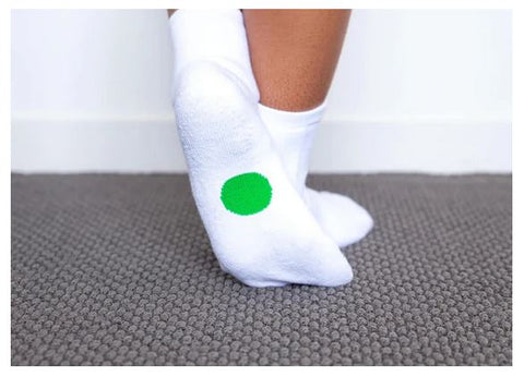 Legs wearing Dot On A Sock quarter crew socks with green dot