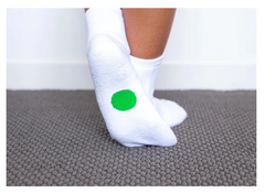 Legs wearing Dot On A Sock white quarter crew socks with green dot