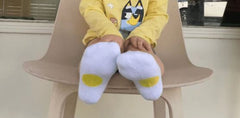 Child wearing white Dot On A Sock ankle socks with yellow dot on soles