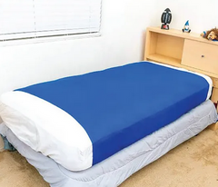 Bedroom setting with a bed fitted with the navy blue Elizabeth Richards sensory compression sheet for calming sensory input, emotional regulation, autism support, ADHD, classrooms, and sleep routines
