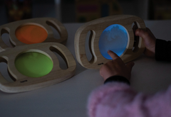 Easy Hold Glow Panels Set of 3 being explored in a dim environment, showing glowing blue, green and orange sensory panels