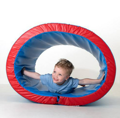 This is an image of a foam and vinyl covered blue tunnel with red rims. There is a small child inside with his arms outstretched.