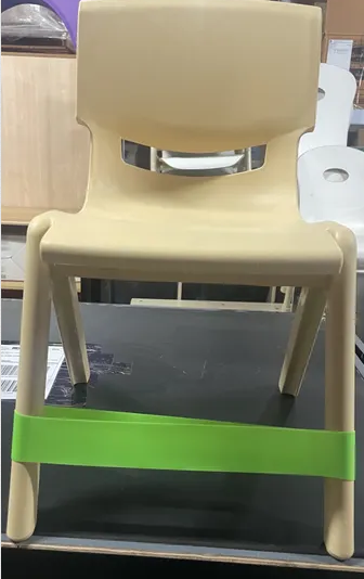 Front view of lime green coloured  Fidget Chair Band stretchy sensory band attached to a classroom chair to support seated movement, focus, sensory regulation and calm during learning and therapy activities