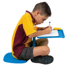 School boy sitting at a the blue Flexi Floor Desk