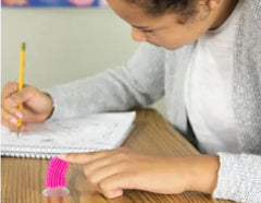 Girl playing with Flick Stick stuck to table