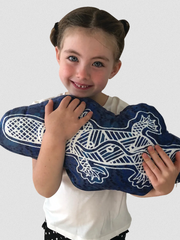 Young girl holding a Gumbula First Nations Marine Animal Cushion with platypus print featuring authentic Indigenous artwork by Uncle John Smith Gumbula