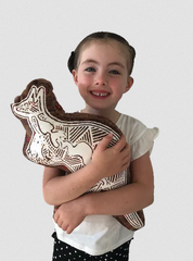 Young girl holding a Gumbula First Nations Land Animal Cushion with kangaroo print featuring authentic Indigenous artwork by Uncle John Smith Gumbula