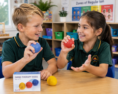 Children using colourful Hand Therapy Eggs together in a school classroom.