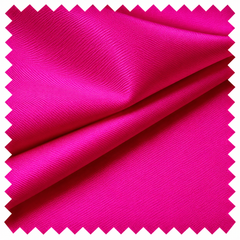 A square swatch of hot pink fabric with a zigzag-cut border
