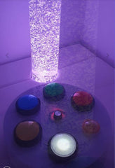 Image of a bubble tube in a sofa podium and with the switchbox to change colours.