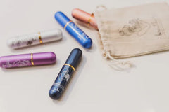 This is an image of a calico bag with a set of 5 inhalers for essential oils. The colours are dark blue, light blue, pale blue, purple and pink. 