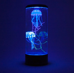 Dark space with a blue lit Jelly Fish Tank – Round Black with two realistic floating jellyfish, colour-changing LED lighting and quiet operation for sensory rooms, therapy clinics, classrooms, aged care settings and home environments.