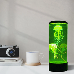 Desk setting with a green lit Jelly Fish Tank – Round Black with two realistic floating jellyfish, colour-changing LED lighting and quiet operation for sensory rooms, therapy clinics, classrooms, aged care settings and home environments.