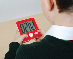 Red coloured Jumbo Digital Timer with large display being used by a student to support time awareness, task management and classroom independence