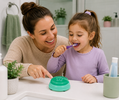 Mum and daughter using a 2-minute toothbrushing timer during their bathroom routine.
