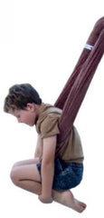 A child sits in a brown, two-layer lycra swing set against a plain white background.