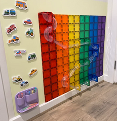  A butter coloured Magnetic wall decal displaying colourful magnetic construction tiles and clear ball-run components for interactive STEM learning and play.