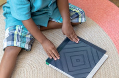 Child using Mindful Motions Sensory Cards with a motion slider for visual exploration, concentration, mindfulness and calming activities